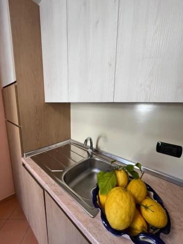 a bowl of fruit on a counter next to a sink at Villa Anna in Minori