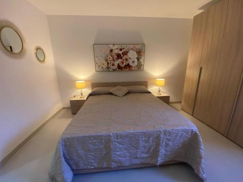 a bedroom with a large bed with two lamps at New 3 Bed Apt with Communal Pool in St Paul's Bay