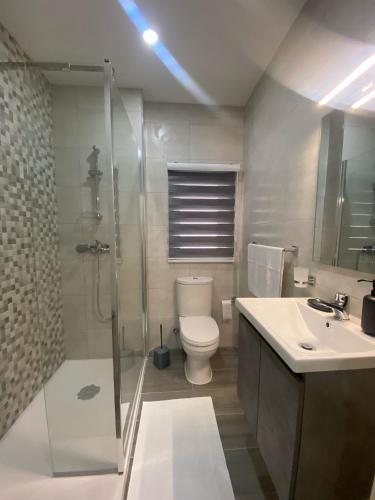 a bathroom with a shower and a toilet and a sink at New 3 Bed Apt with Communal Pool in St Paul's Bay