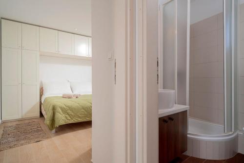 a bedroom with a bed and a tub in a room at Everything just a few steps away in Hvar