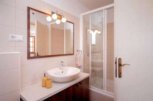 a bathroom with a sink and a shower with a mirror at Everything just a few steps away in Hvar