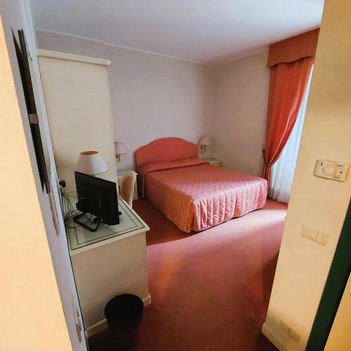 Postel nebo postele na pokoji v ubytování Albergo Ristorante Bigiù