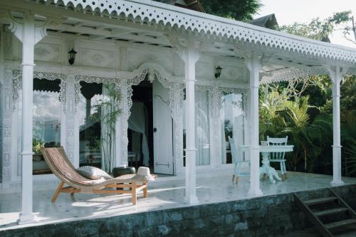 a white gazebo with chairs and a table at White Tortoise Eco Villa's in Uluwatu