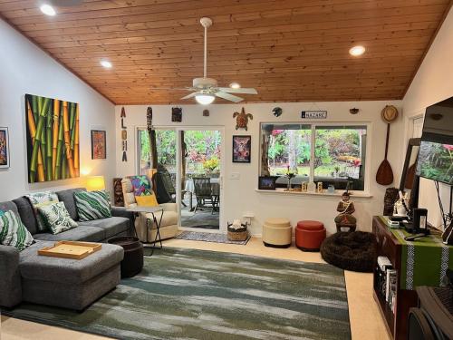a living room with a couch and a ceiling at Aloha Ohia Hale home in Volcano