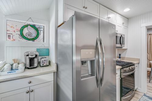 a stainless steel refrigerator in a kitchen with white cabinets at 339CL 339 Claressa in Avalon