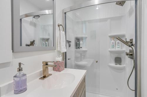 a white bathroom with a sink and a shower at 339CL 339 Claressa in Avalon