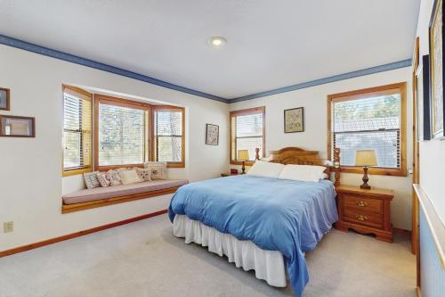 a bedroom with a bed and two windows at Tuna Bush in Truckee