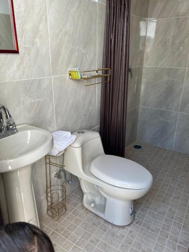 a bathroom with a toilet and a sink at Casa Jardín in Tequila