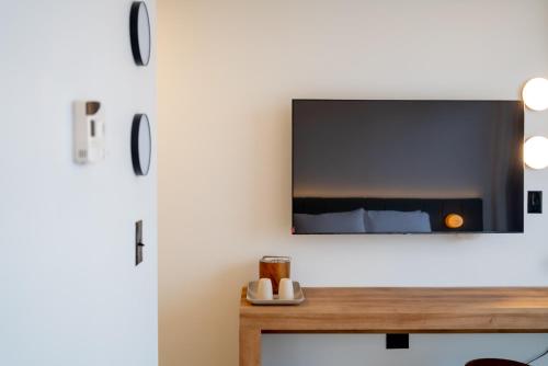 a living room with a tv on a wall at Dayton Vitality Hotel - Downtown in Dayton