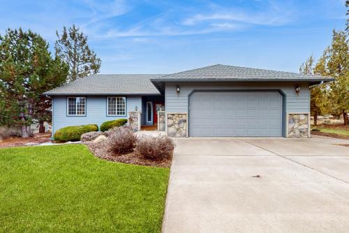 a house with a garage in a yard at Eagle Crest Nature Retreat in Redmond