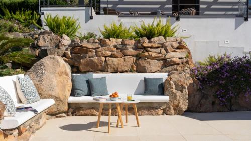 a patio with a white couch and a table at Villa Vittoria 8 by Massimo Villas in Gratteri