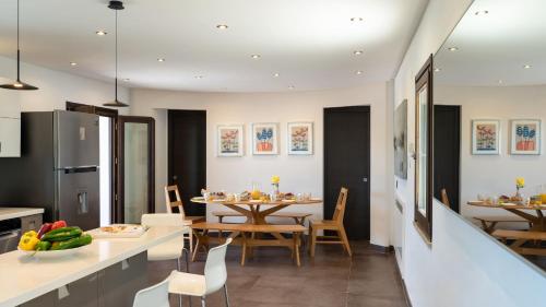 a kitchen and dining room with a table and chairs at Villa Vittoria 8 by Massimo Villas in Gratteri