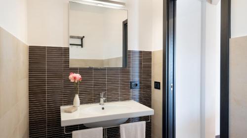 a bathroom with a sink and a mirror at Villa Vittoria 8 by Massimo Villas in Gratteri