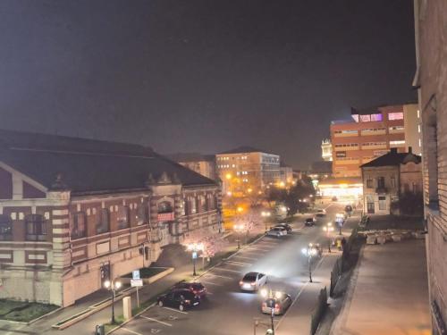 a city street at night with cars parked on the street at Zen Life Center Suite in Drobeta-Turnu Severin
