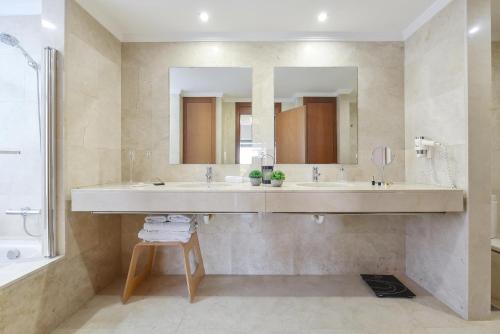 a bathroom with two sinks and a large mirror at Salobre Villa 2 by Villagrancanaria in Salobre