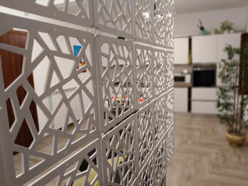 a white wall with a metal fence in a room at Coppito Apartment in Coppito