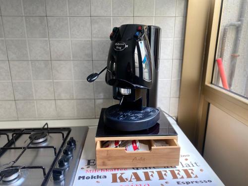 a black coffee maker sitting on top of a counter at Casa Alleria in Battipaglia