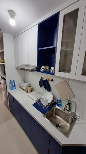 a kitchen with a sink and a counter top at Blue Belle Staycation Pollux Habibie in Batam Center