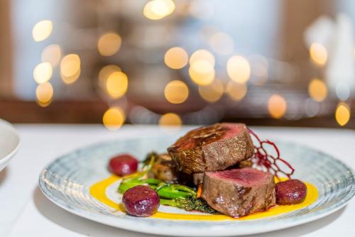 a plate of food with meat and vegetables on a table at The Park Hotel in Tenby