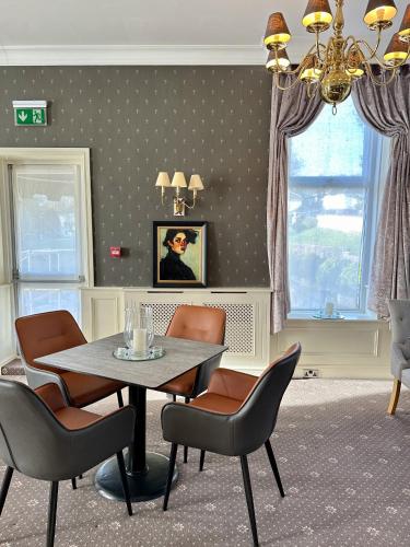 a dining room with a table and chairs at The Park Hotel in Tenby