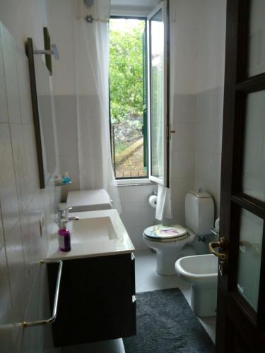 a bathroom with a sink and a toilet and a window at Da Cate in Monterosso al Mare