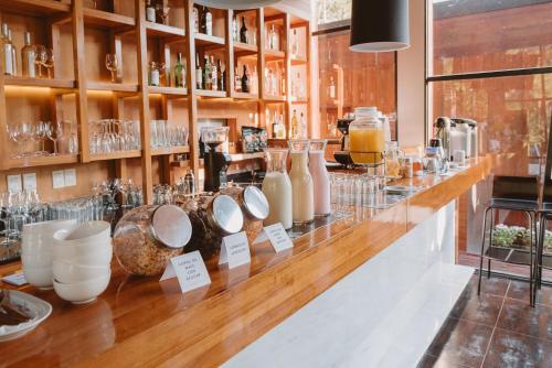 a bar with vases and other items on display at Puerto Dijama Hotel Boutique in Carmelo