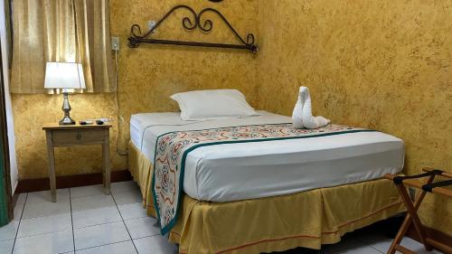 a bedroom with a bed with a stuffed animal on it at La Posadita de Bolonia in Managua