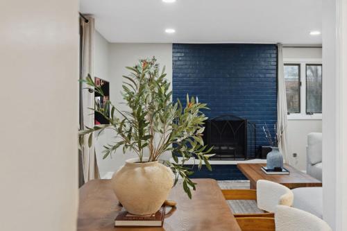 a living room with a vase on a wooden table at Elevated Stay 3BR in Addison in Addison