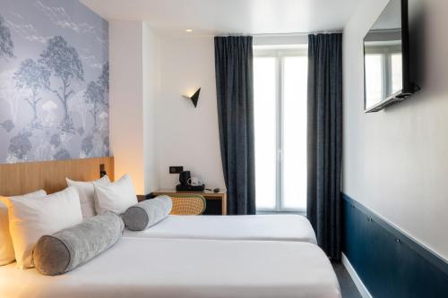 Кровать или кровати в номере Hôtel WYLD Saint Germain