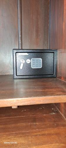 a television sitting on top of a wooden shelf at Oryza Guest House in Desana