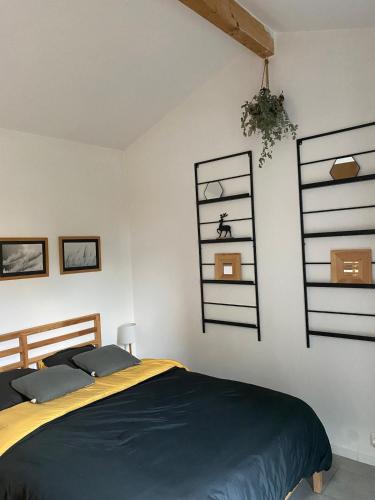 a bedroom with a bed and shelves on the wall at LES GITES CHEROIS maison familiale 13 personnes in Les Chères
