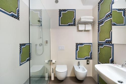a bathroom with a shower and a toilet and a sink at Saracen Sands Hotel & Congress Centre - Palermo in Isola delle Femmine