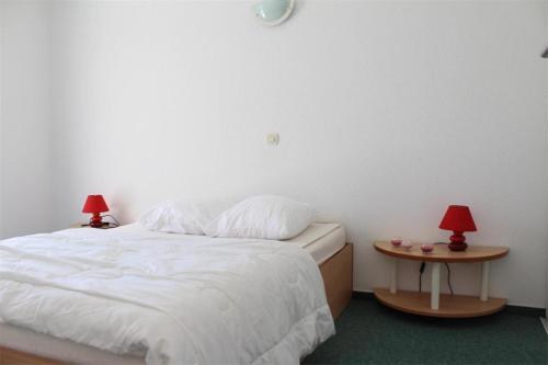 a bedroom with a bed and two tables with lamps at Appt 2 pièces LA ROCHELLE - LR030-E16 in La Rochelle