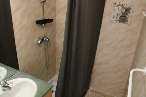 a bathroom with a shower curtain and a sink at Appt 2 pièces LA ROCHELLE - LR030-E16 in La Rochelle