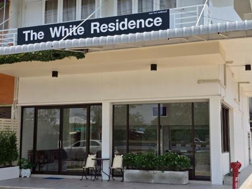 a building with a sign that reads the writtle residence at The White Residence in Chanthaburi