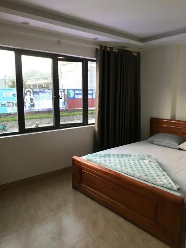a bedroom with a bed and a window with a train at Bich Phuong Hotel 3 in Ha Giang