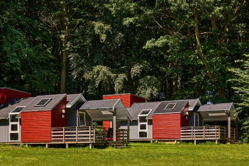 a row of houses with red and gray roofs at Husodde Strand Camping & Cottages in Horsens