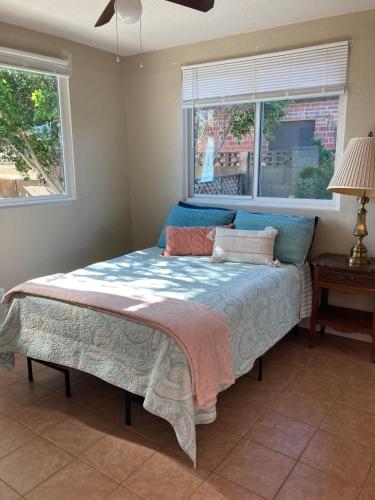 a bed in a bedroom with a window at Pepper Bungalow in Mesa
