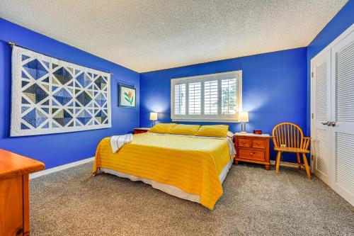 a blue bedroom with a bed and a chair at St Johns River Retreat in Welaka with Dock Access in Welaka