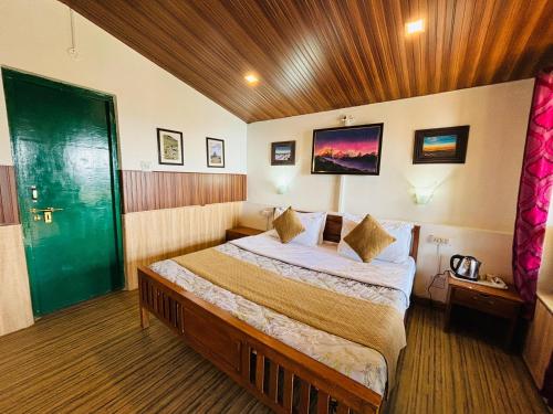 a bedroom with a large bed in a room at Room on the Roof, Viraatkhai-Chakrata, By Himalayan Eco Lodges in Chakrāta