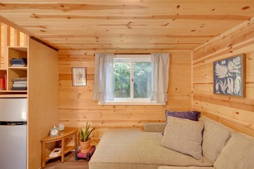 a living room with a couch and a window at Modern Lynnwood Tiny House 16 Mi to Seattle! in Lynnwood