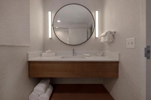 a bathroom with a sink and a mirror at Fairfield by Marriott Inn & Suites Denver Airport at Gateway Park in Denver