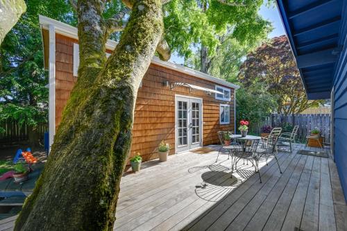a wooden deck with a table and chairs on a house at Modern Lynnwood Tiny House 16 Mi to Seattle! in Lynnwood