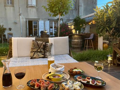 a table with plates of food and glasses of wine at Les volets verts in Saint-Laurent-de-la-Cabrerisse