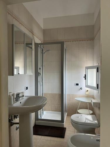 a bathroom with a sink and a toilet and a shower at La Torre e il Mare Rooms by STHEY in Monopoli