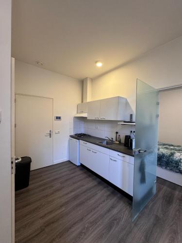 a kitchen with white cabinets and a counter top at 86 1 City Appartement in Enschede