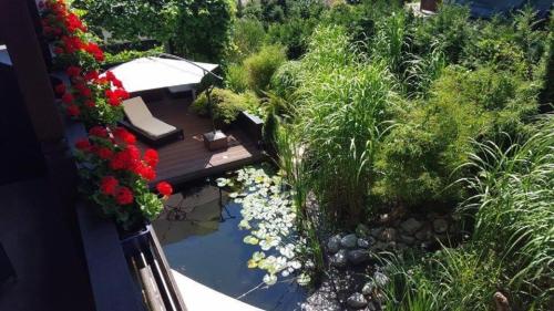 an aerial view of a garden with flowers and a deck at Gästehaus Tanneck in Reit im Winkl