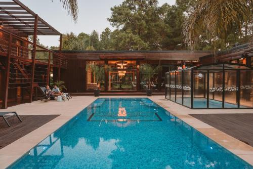 a swimming pool in the middle of a house at Puerto Dijama Hotel Boutique in Carmelo