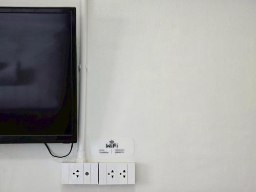 a flat screen tv hanging on a wall at The White Residence in Chanthaburi