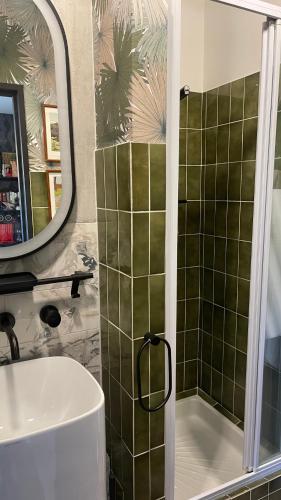 une salle de bain avec une douche, un lavabo et un miroir dans l'établissement La galerie, à Mulhouse